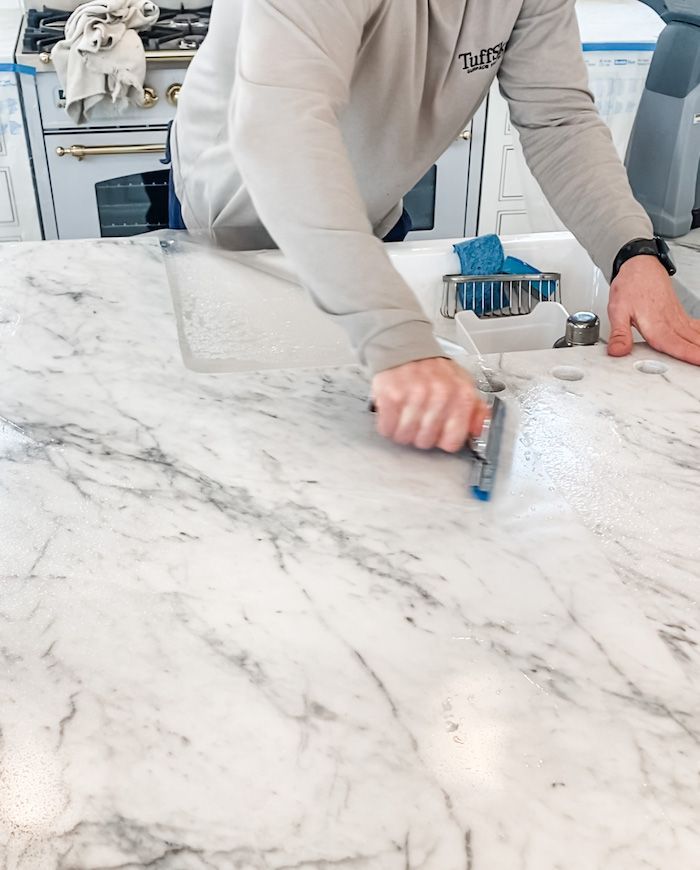 Applying marble sealer evenly on countertop