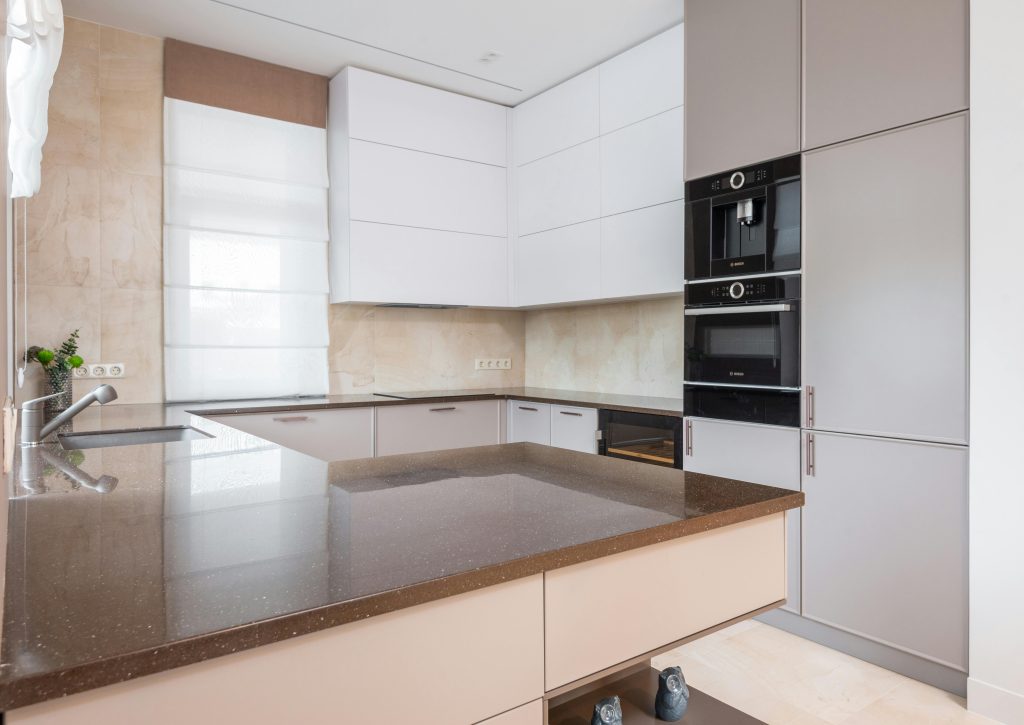 Sealing marble countertop in a kitchen and bathroom to protect against stains.