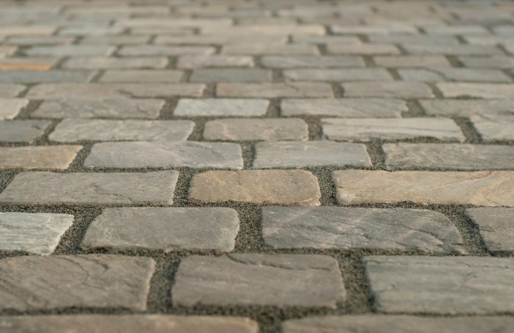 Close-up of professionally installed bluestone pavers with sand-filled joints showcasing durable outdoor stone paving